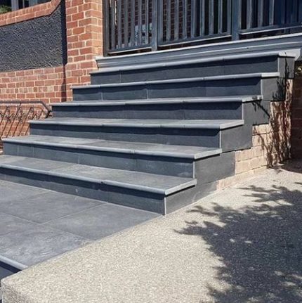 Brick and concrete front steps installed by Remodel With Alison in Long Island, New York.