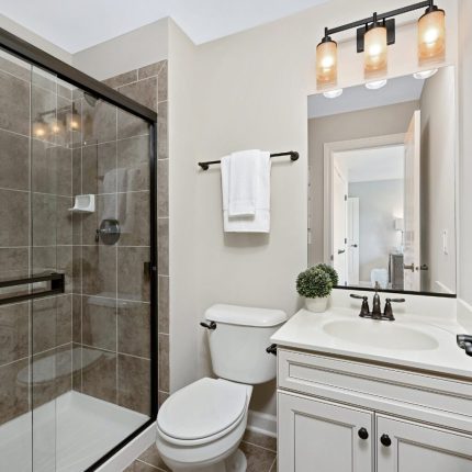 Elegant bathroom remodel in Long Island with walk-in shower and modern vanity by Remodel With Alison.