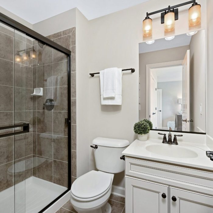 Elegant bathroom remodel in Long Island with walk-in shower and modern vanity by Remodel With Alison.