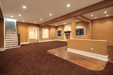 Modern full finished basement with carpet and hardwood flooring in Long Island home