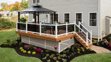 Custom-built backyard deck with railing in Long Island, NY